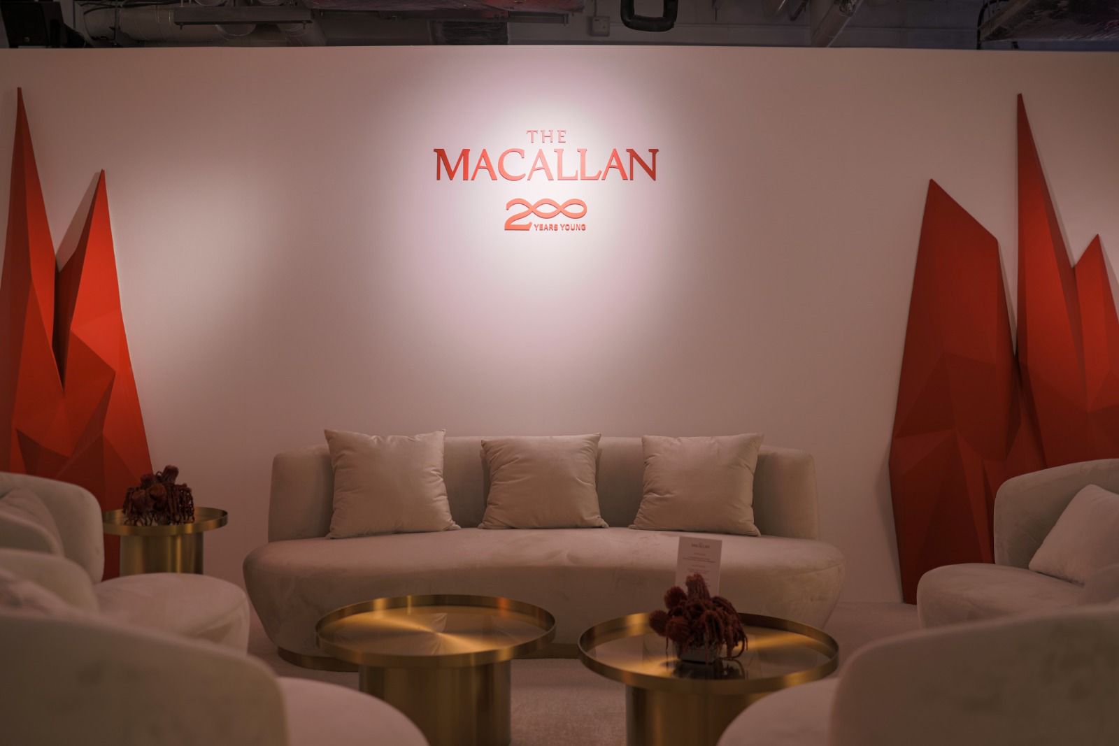 Luxury brand lounge setup with The Macallan 200 Years display, elegant seating, and premium event ambiance