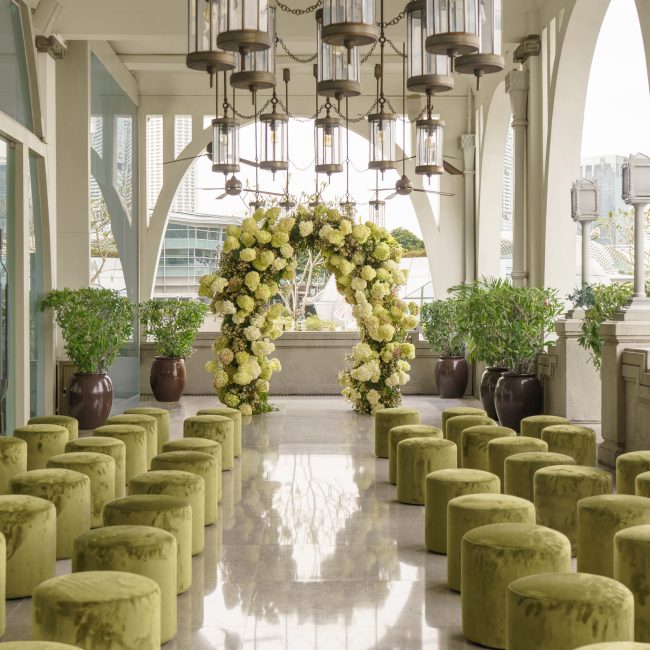Elegant wedding event setup with floral decorations and modern circular wooden planter centerpiece