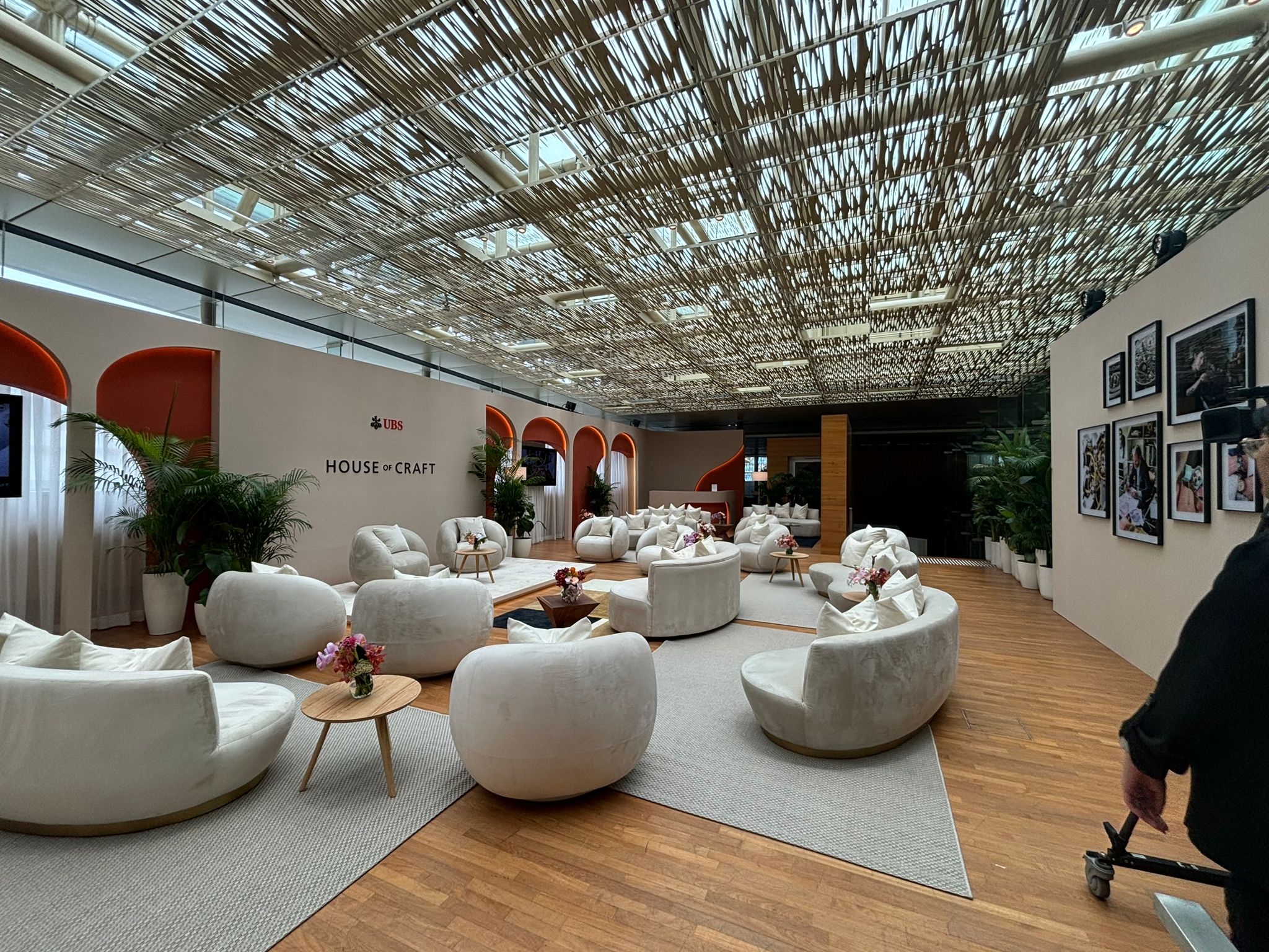 Luxury corporate event lounge with modern seating, branded backdrop, and premium experiential design